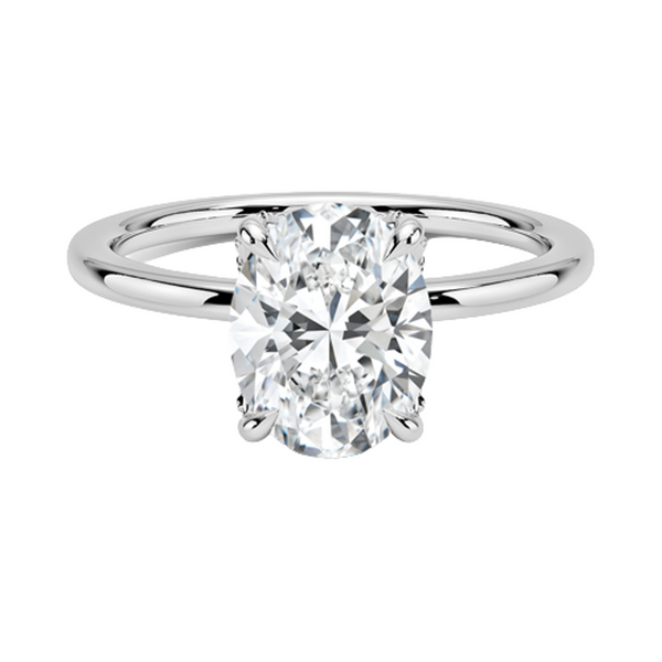Celestia Crest features a stunning oval diamond elevated by a hidden halo and intricate claw prongs, set atop a high-polish band for a flawless blend of sparkle and sophistication.