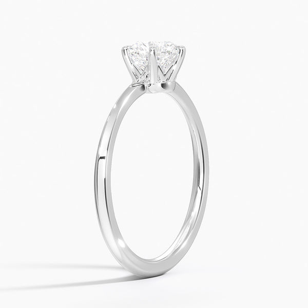 Solenya Whisper is a sleek, minimalist solitaire ring that blends subtle elegance with enduring craftsmanship, letting its brilliant center diamond speak volumes.