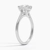 A sweeping cathedral-style solitaire ring with hidden diamond accents and a round brilliant center, blending elegance and modern refinement.