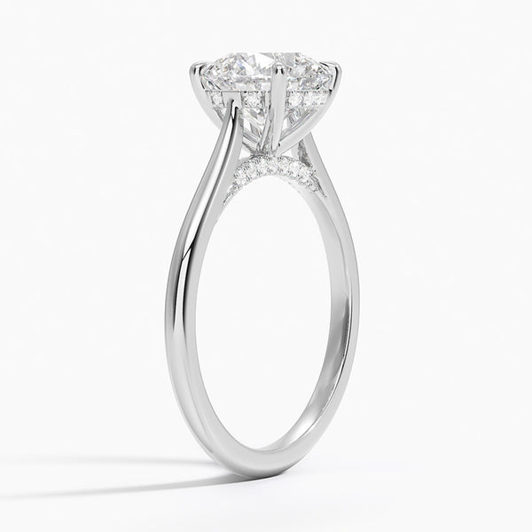 A sweeping cathedral-style solitaire ring with hidden diamond accents and a round brilliant center, blending elegance and modern refinement.