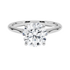 A sweeping cathedral-style solitaire ring with hidden diamond accents and a round brilliant center, blending elegance and modern refinement.