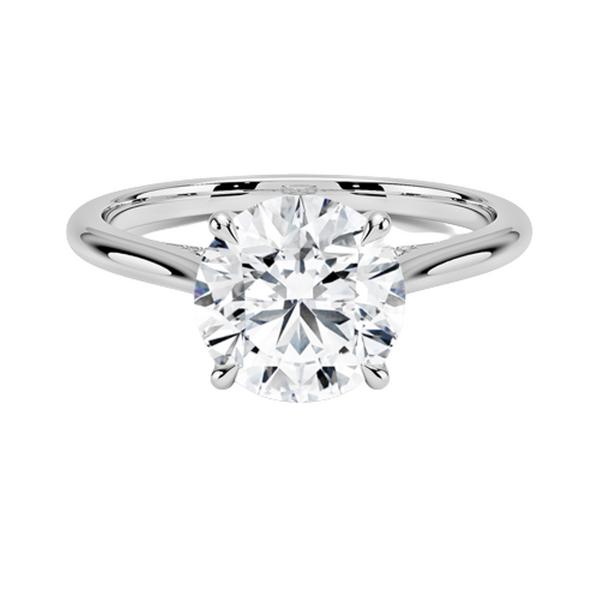A sweeping cathedral-style solitaire ring with hidden diamond accents and a round brilliant center, blending elegance and modern refinement.