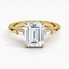 The Solmaris Crest ring showcases a commanding emerald-cut diamond framed by trapezoid side stones, exuding modern elegance and architectural beauty.