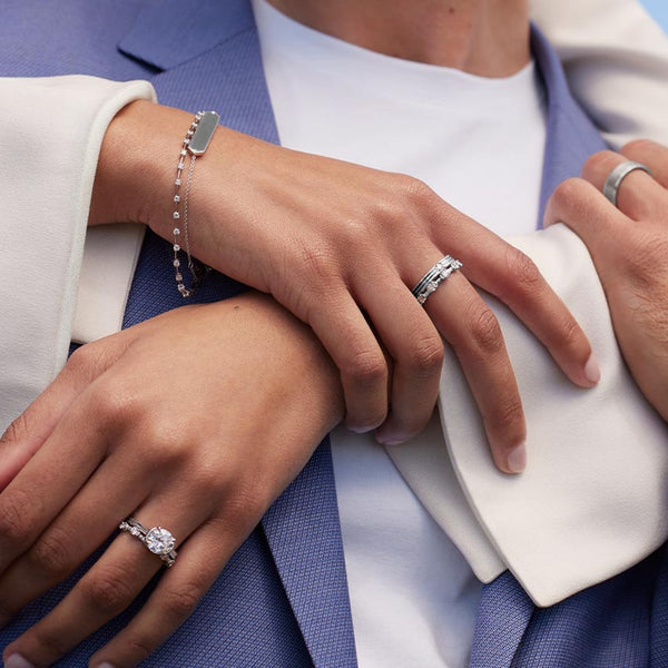 A sleek cathedral-style ring with split shoulders that elegantly lift the diamond in a graceful arc.